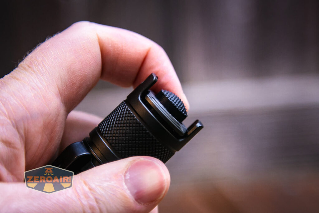 JETBeam TH10R Tactical flashlight showing dual paddle switch (seesaw)