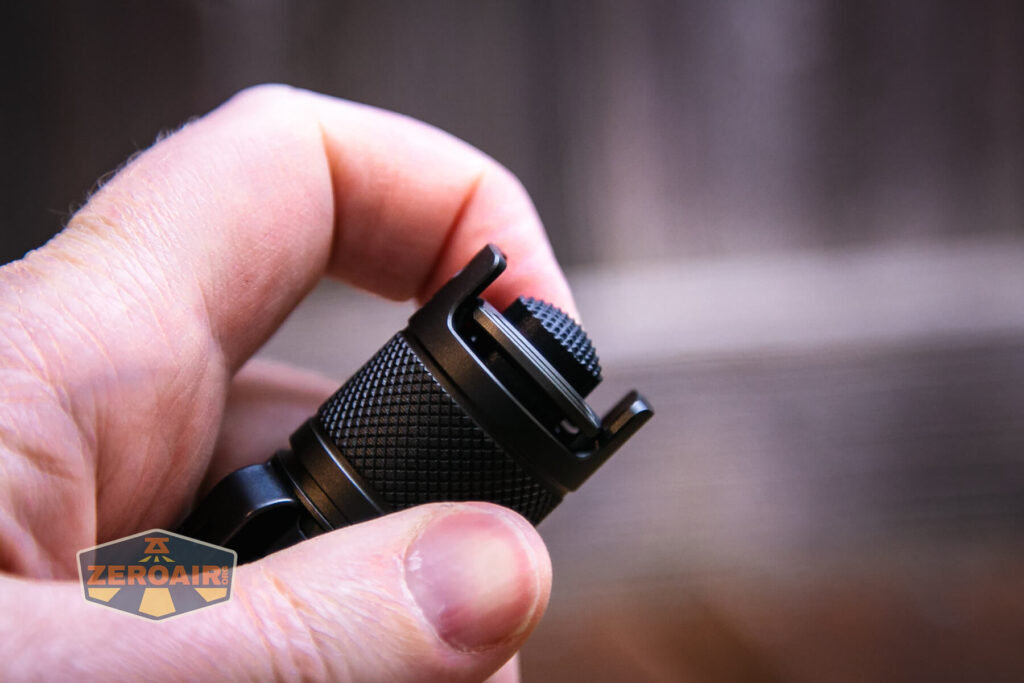 JETBeam TH10R Tactical flashlight showing dual paddle switch (seesaw)