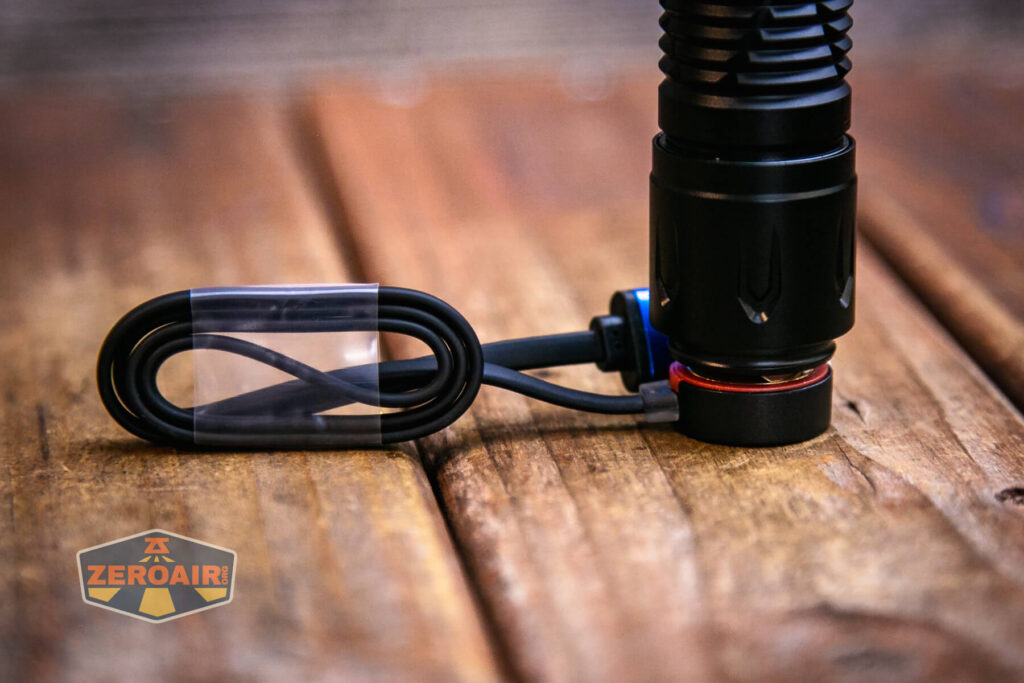 Olight Javelot Pro 2 flashlight on charging cable base