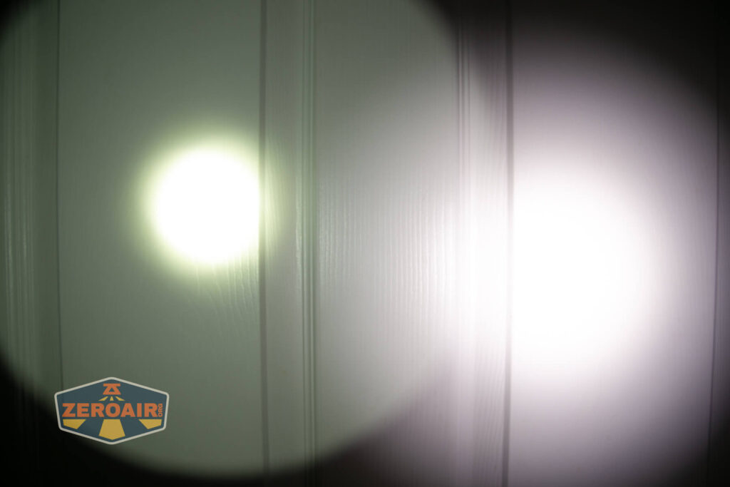 Two flashlight beams, one small and yellowish on the left and one large and white on the right, are projected onto a paneled white surface. A ZeroAir logo appears in the bottom left corner.