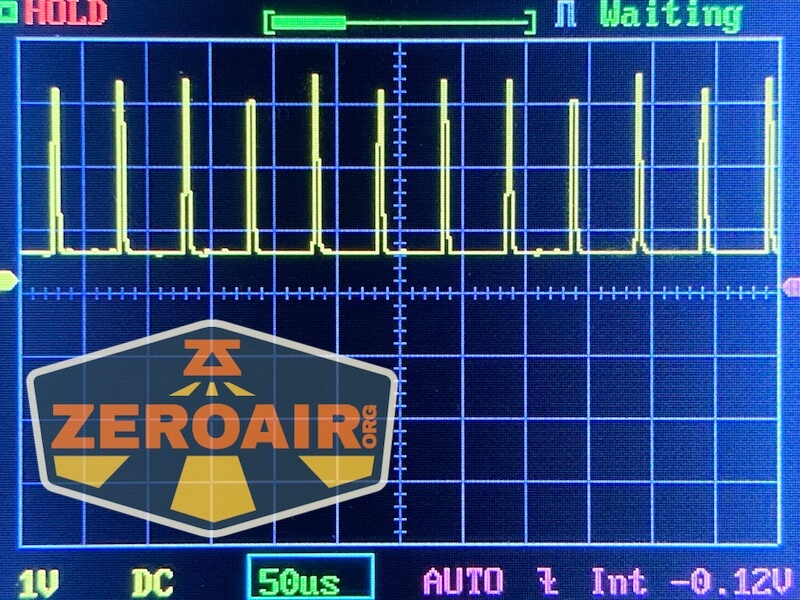 Oscilloscope screen showing a repeating square wave signal with a 1V per division scale and 50 microsecond time base. The screen has a ZEROAIR.org watermark in the lower left corner.