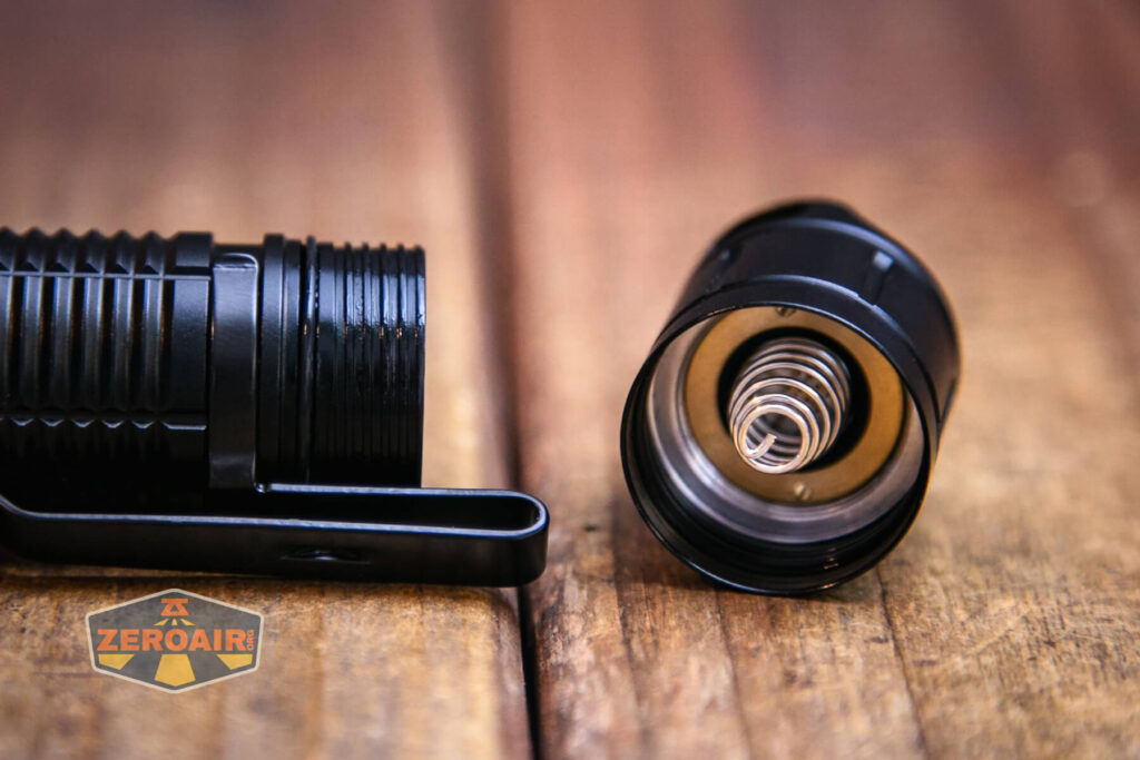 Soonfire MX75 flashlight showing tailcap threads and springr