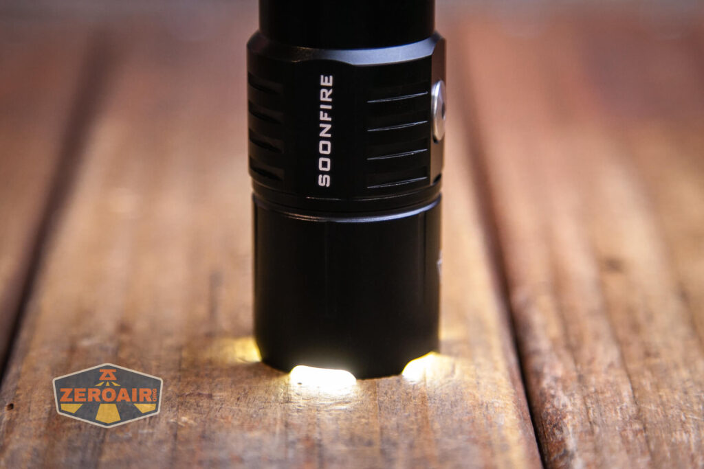 Soonfire MX75 flashlight emitter on while headstanding