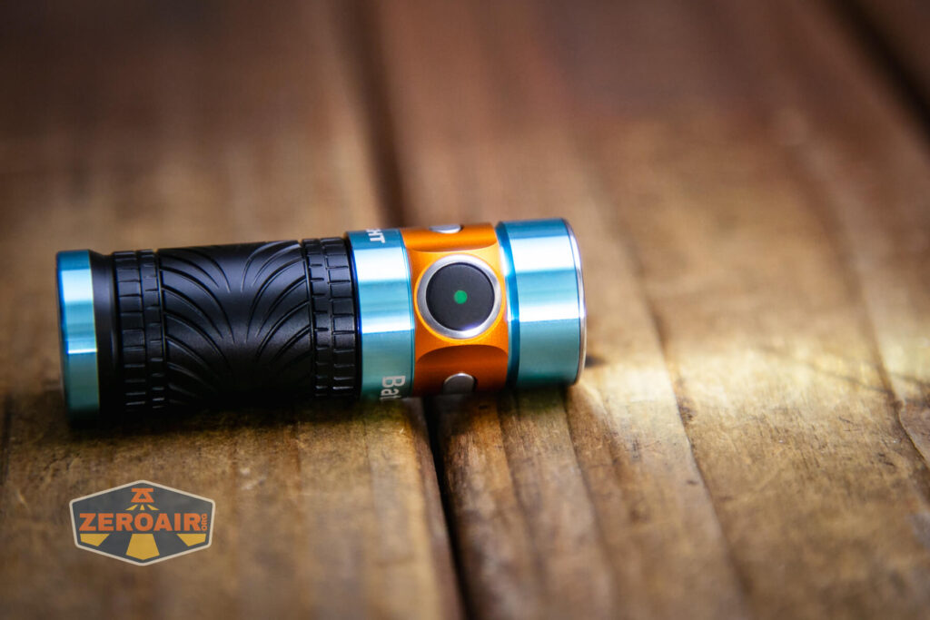 Olight Baton 3 Roadster emitter on and switch lit green