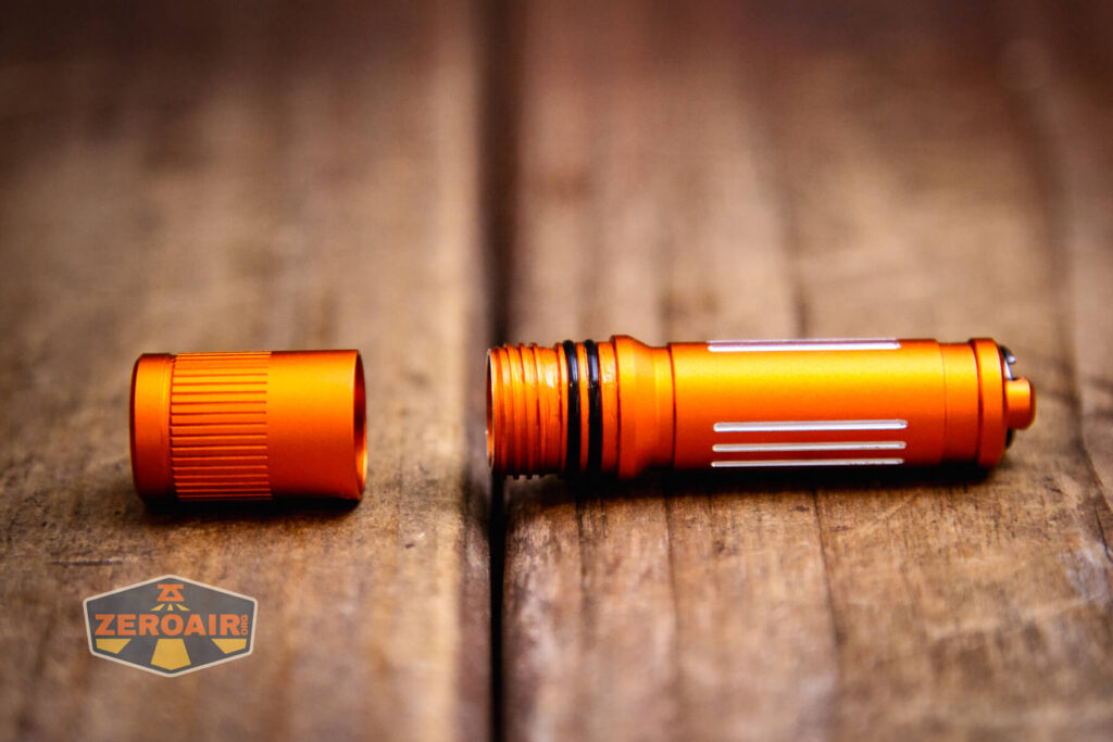 Olight i3E EOS Orange flashlight head off body showing threads