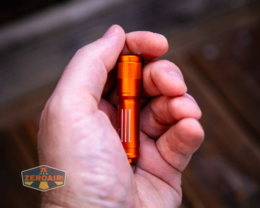 Olight i3E EOS Orange flashlight in hand