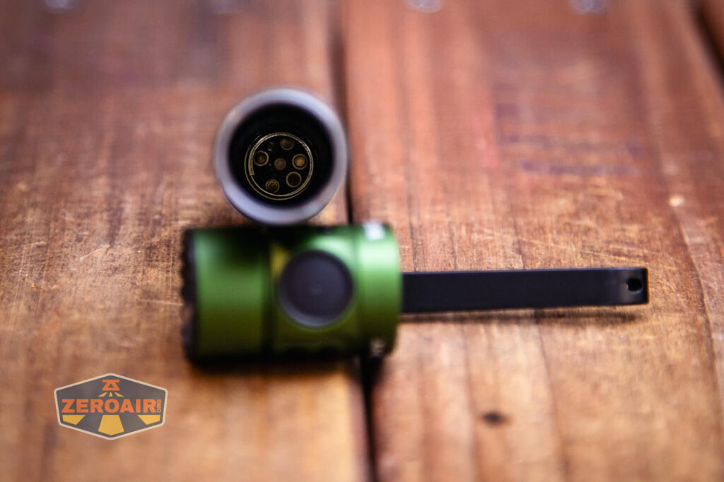 Olight Warrior Mini 3 flashlight showing tail contacts