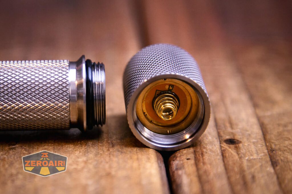 Gift Glow A1 reflector flashlight showing threads and spring