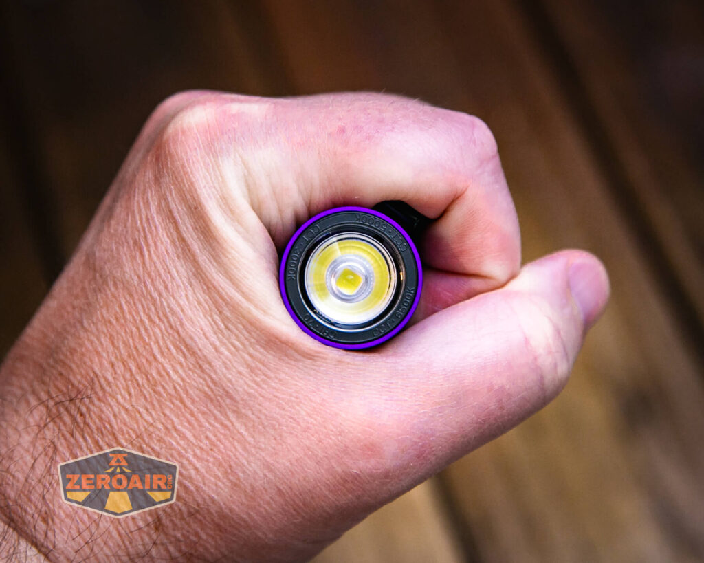 Olight Baton 3 Pro Max purple flashlight in hand