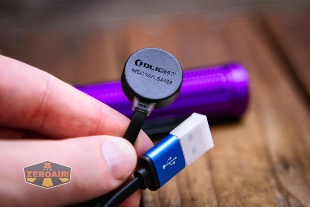 Olight Baton 3 Pro Max purple flashlight showing charging base