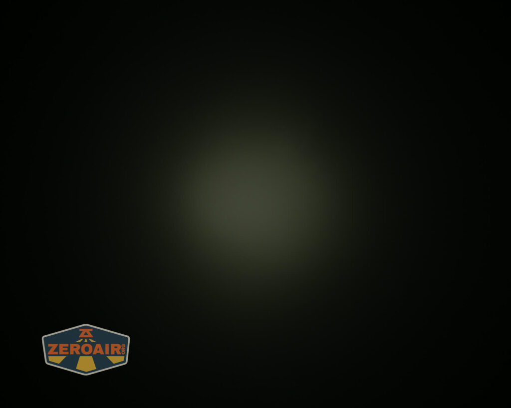 A dim, circular light source is visible in the center of a dark background. The ZeroAir logo appears in the lower left corner of the image.