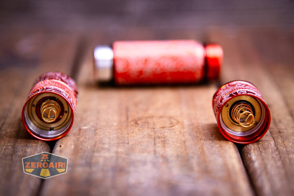 Scrollwork engraved Convoy S2 flashlight showing internal springs