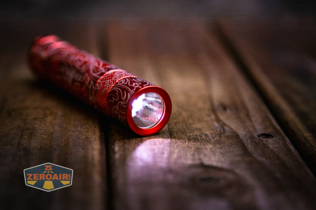 Scrollwork engraved Convoy S2 flashlight emitter on and optic 