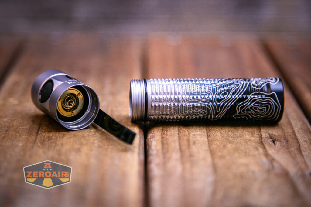 Olight Baton 3 Pro Silver Ridge showing head contacts and threads