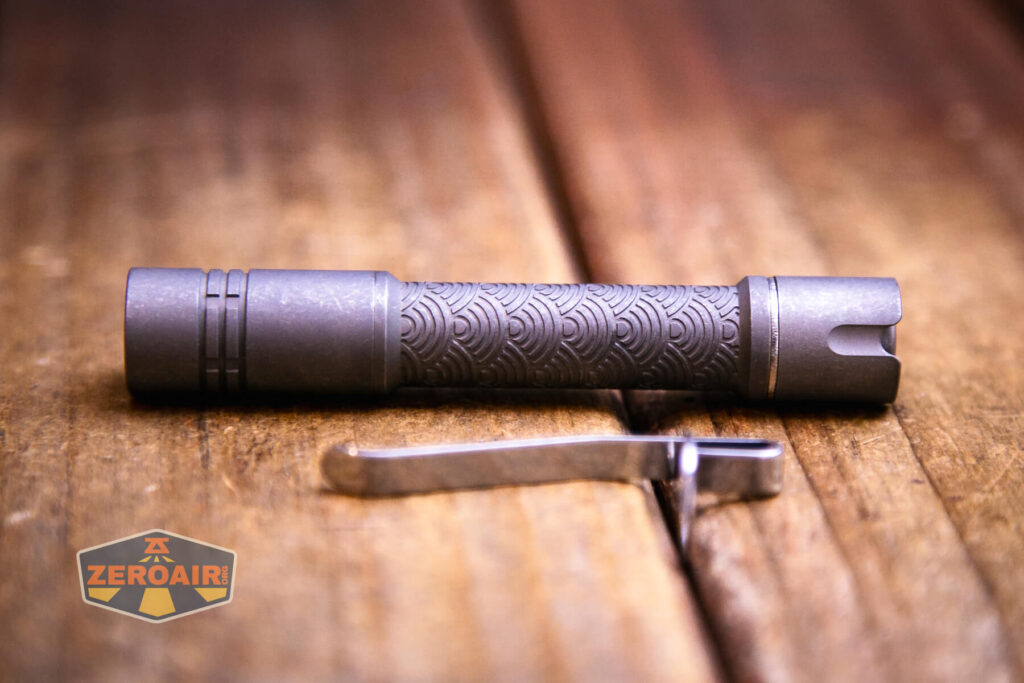 ReyLight Pineapple Mini Seigaiha flashlight in titanium with pocket clip blank in place