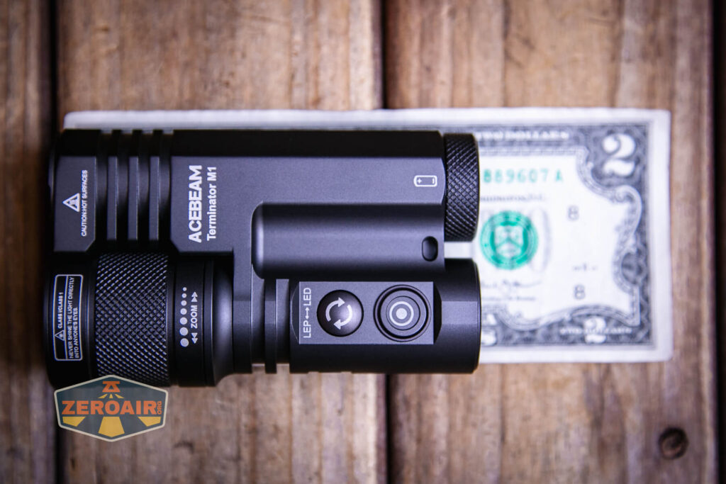 Acebeam Terminator M1 flashlight on two dollar bill