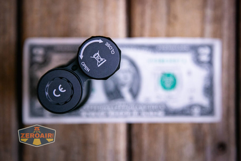 Acebeam Terminator M1 flashlight on two dollar bill