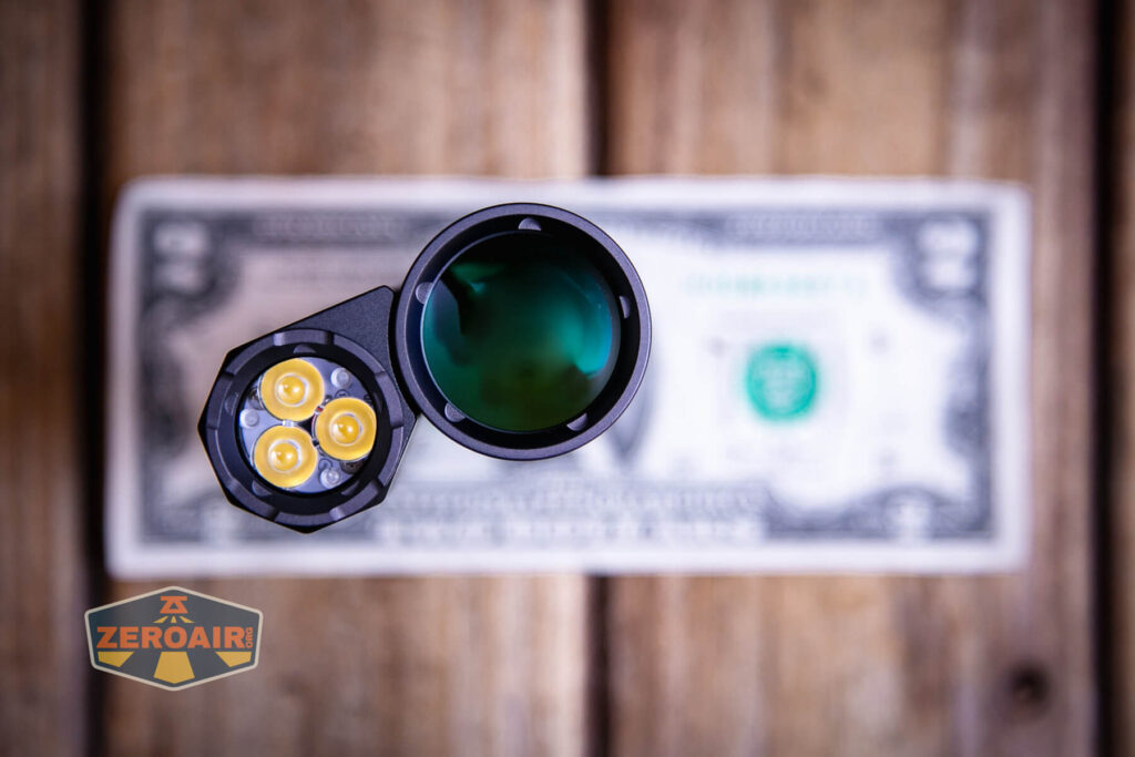 Acebeam Terminator M1 flashlight on two dollar bill