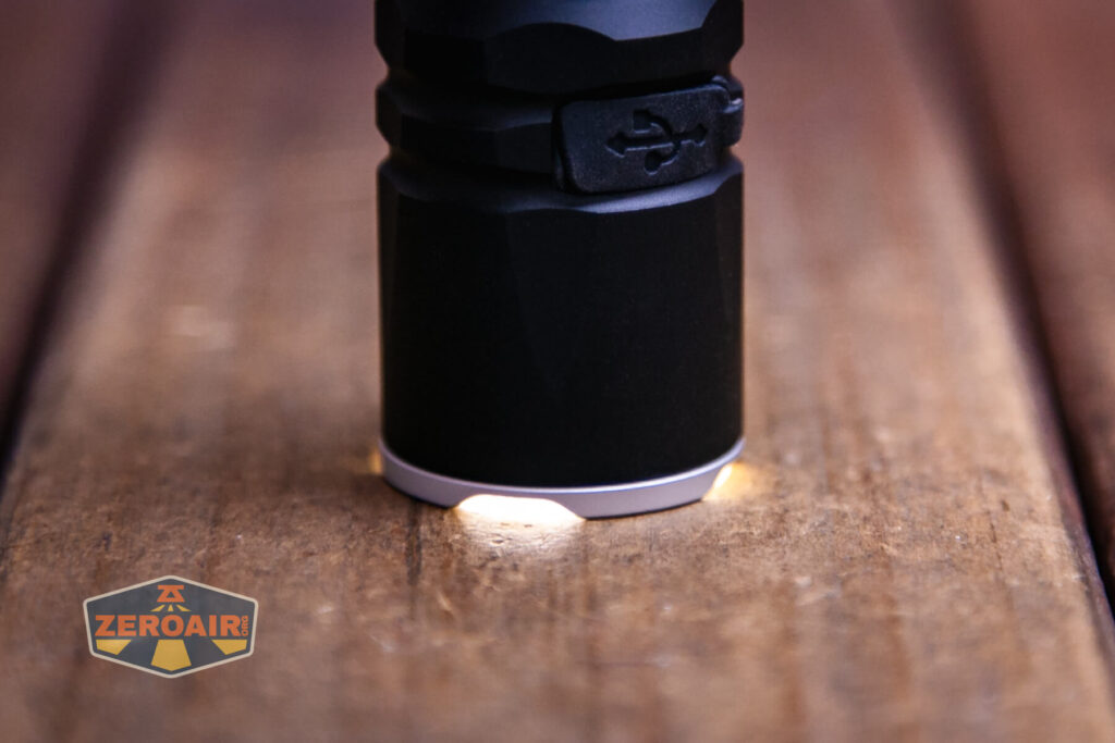 Wurkkos TD03 tactical flashlight emitter on and headstanding