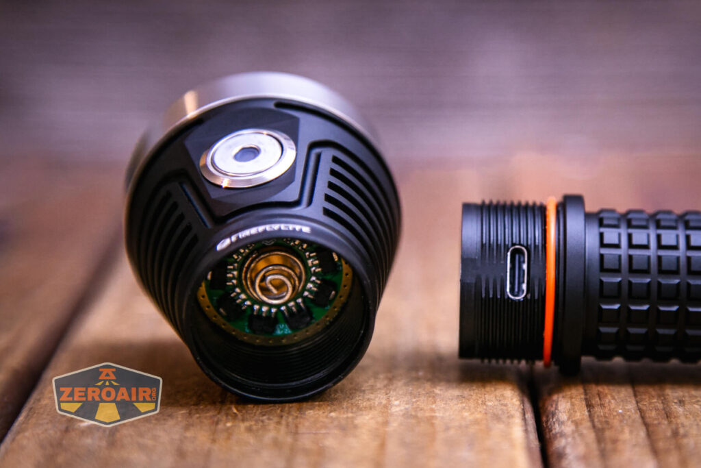 FireflyLite E12C flashlight head removed showing spring and threads