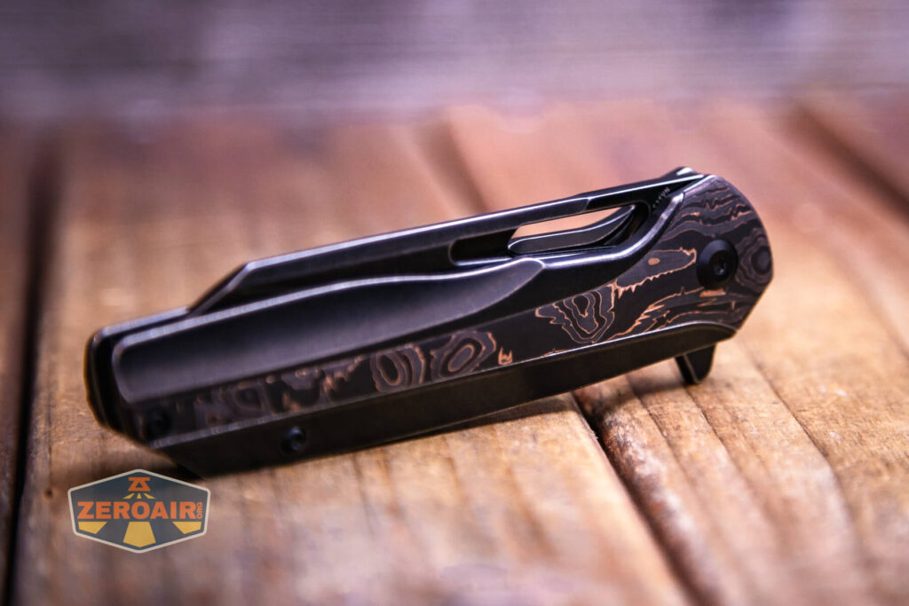 Kansept Shard blackwashed titanium knife closed carbon fiber copper side view