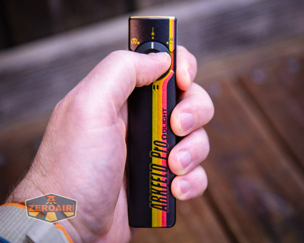 Olight Arkfeld Pro Racing Stripes flashlight in hand