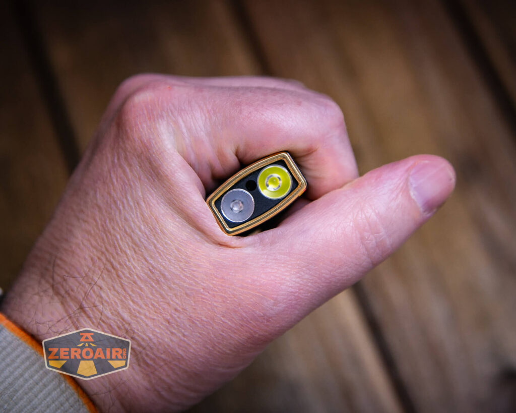 Olight Arkfeld Pro Racing Stripes flashlight in hand