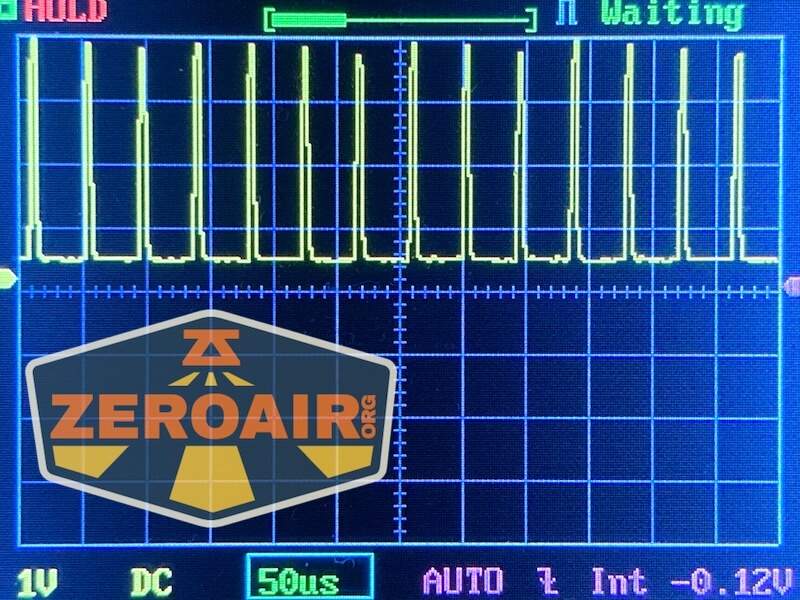 A digital oscilloscope screen displays a square wave signal in yellow, with settings showing 1V per division and 50 microseconds per division. The ZeroAir.org logo and a RovyVon E30 Pro MAO flashlight are featured in the bottom left corner.