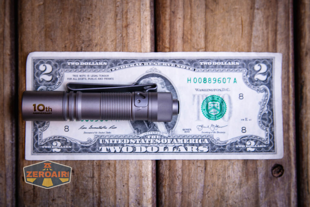 Acebeam Pokelit AA Ti 10th Anniversary flashlight on a two dollar bill