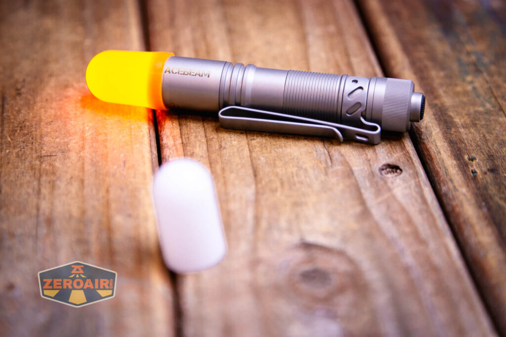 Acebeam Pokelit AA Ti 10th Anniversary flashlight with orange diffuser on