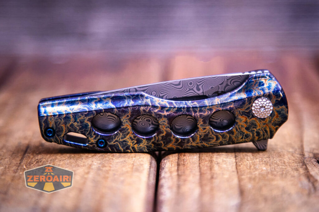 Kansept Cassowary titanium flipper knife closed, showing holes in scale