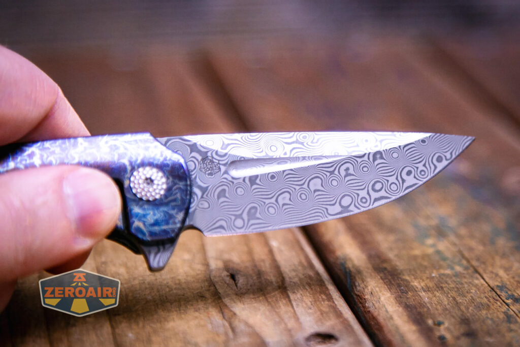 Kansept Cassowary titanium flipper knife damascus blade detail