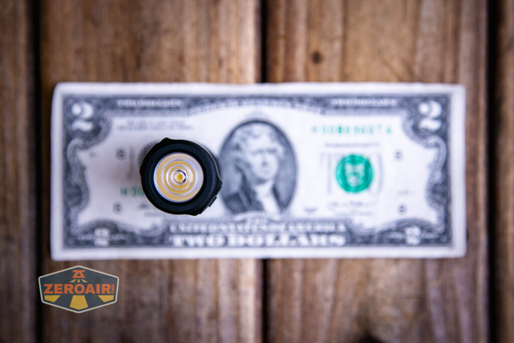Sofirn SC13 Nichia 519a flashlight on a two dollar bill