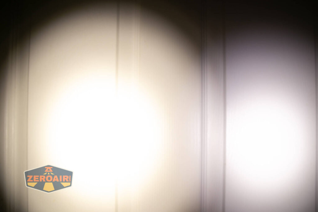 Tactile Turn Apollo flashlight beamshots on door compared to nichia 219b