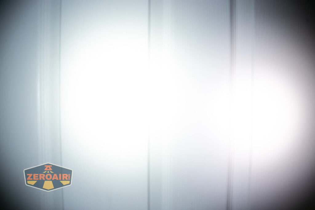 Vastlite Sima flashlight beamshots on door (at 1') compared to nichia 219b 4500K