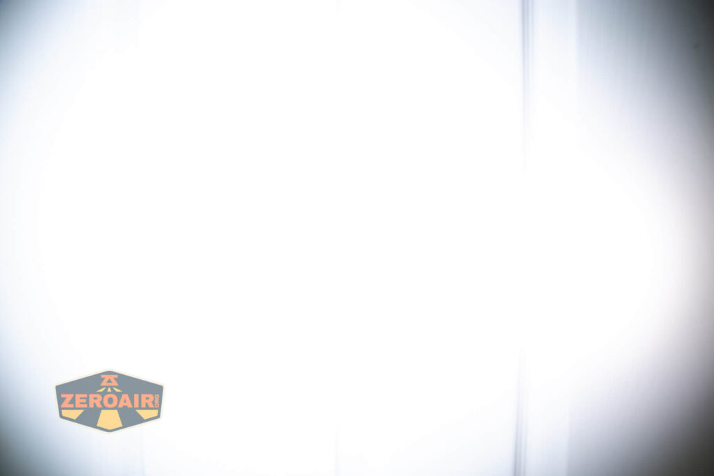 Vastlite Sima flashlight beamshots on door (at 1') compared to nichia 219b 4500K