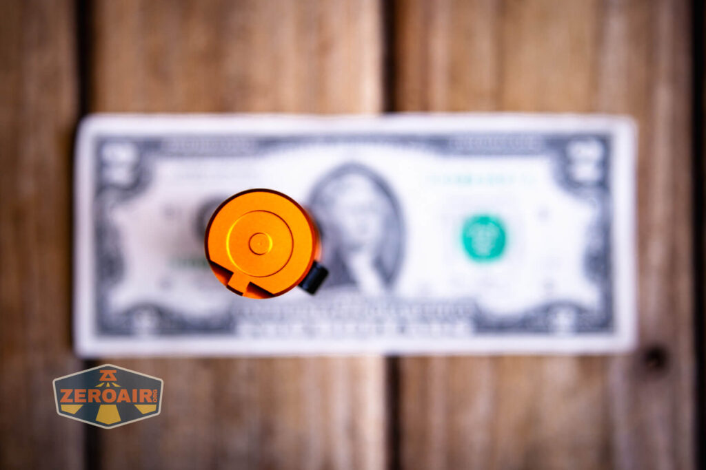 Wurkkos FC11C Halloween flashlight  on a two dollar bill