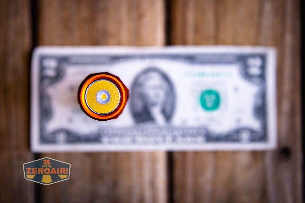 Wurkkos FC11C Halloween flashlight  on a two dollar bill