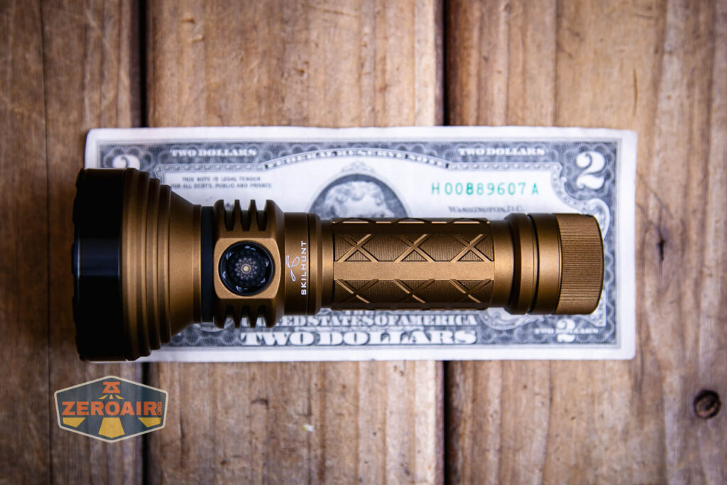 Skilhunt EC500 Coyote neutral white flashlight on a two dollar bill