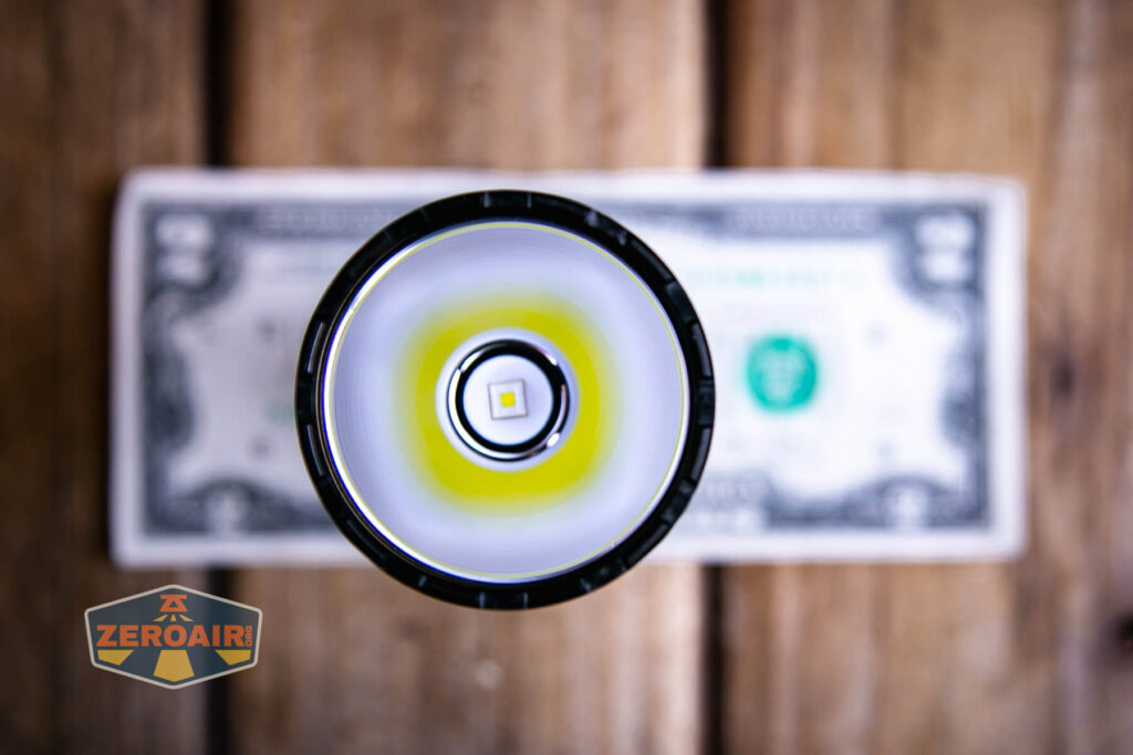 Skilhunt EC500 Coyote neutral white flashlight on a two dollar bill