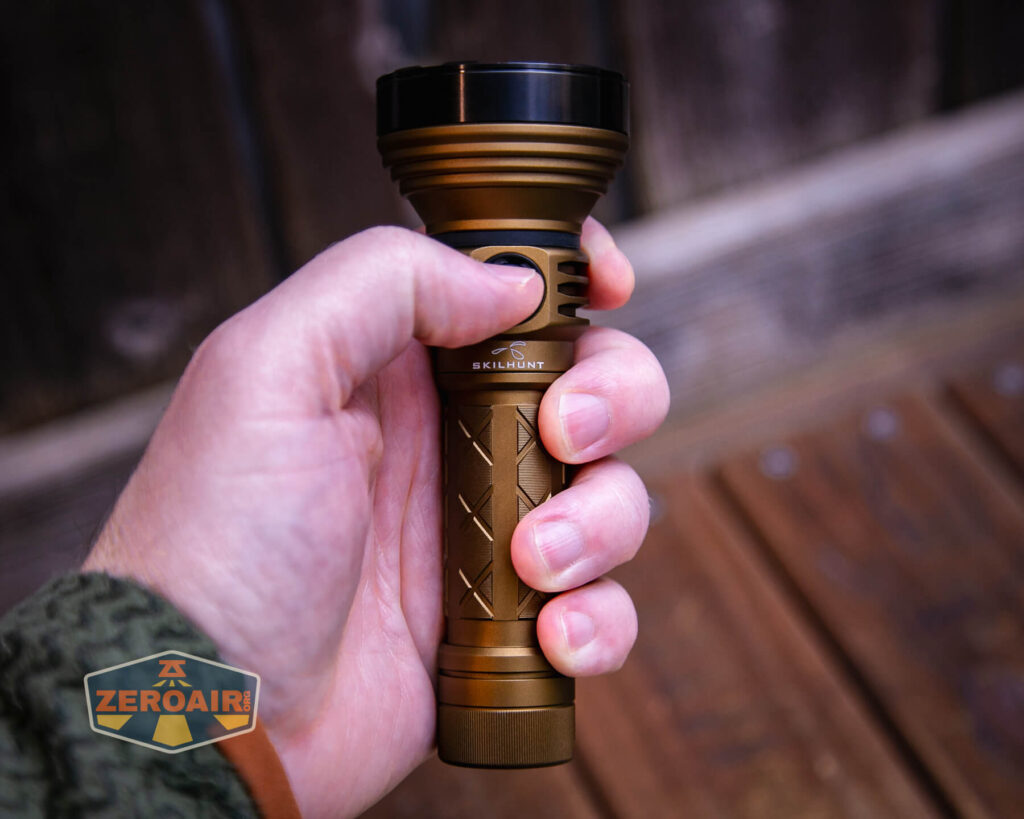 Skilhunt EC500 Coyote neutral white flashlight in hand