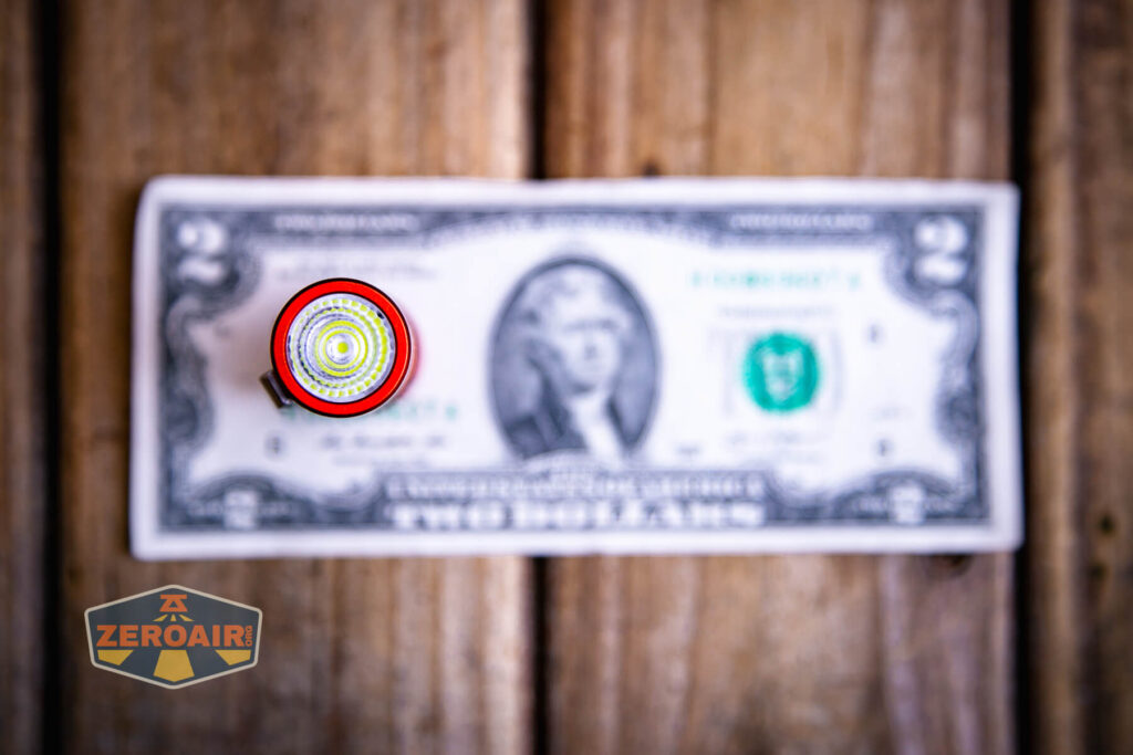 Wurkkos TS10 SG flashlight top down views on two dollar bill