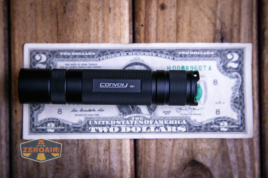Convoy S2+ B35AM flashlight on a two dollar bill