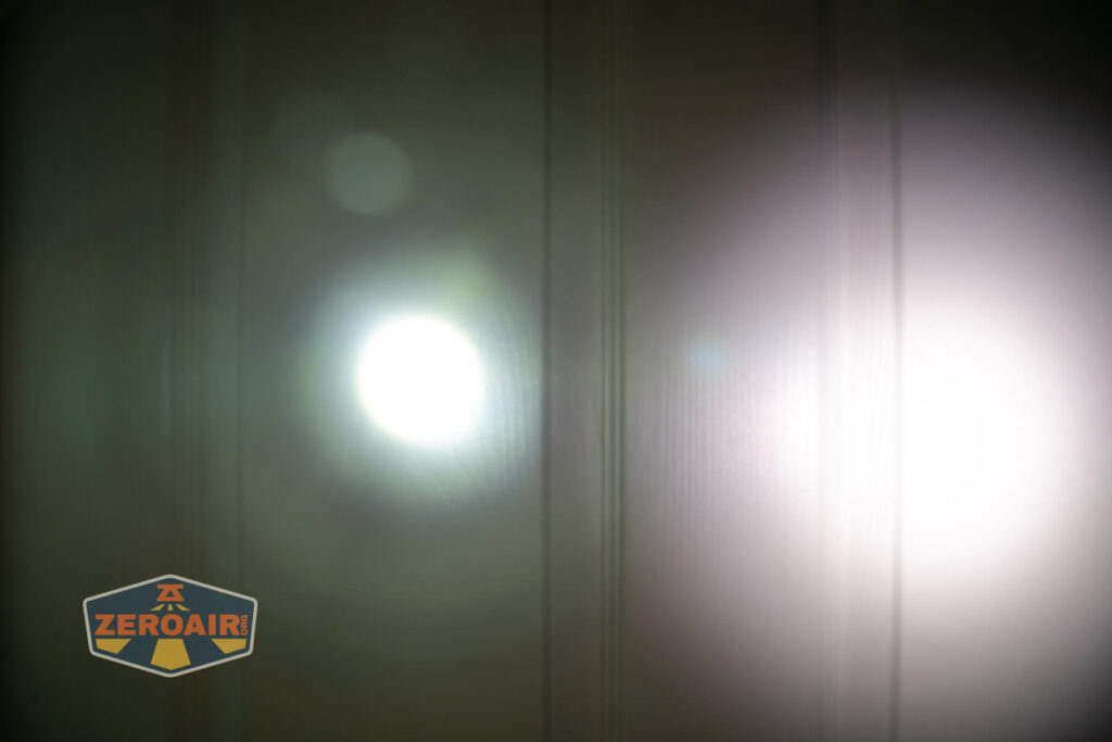 Maratac Mini LEP Cosmos flashlight on a two dollar bill