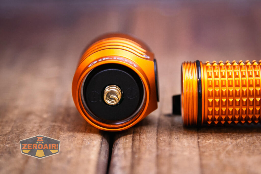 Olight Baton Turbo Orange flashlight head off showing spring and threads