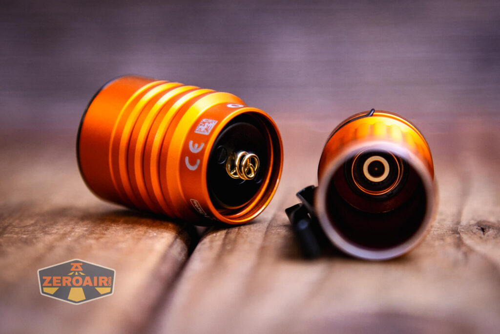 Olight Baton Turbo Orange flashlight head off showing spring and internal spring