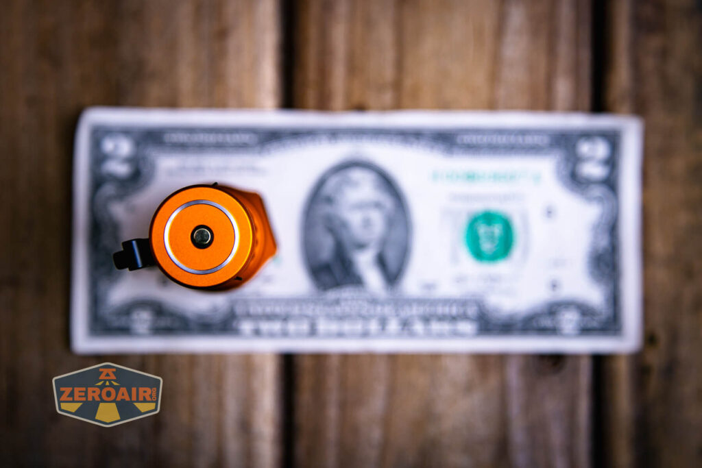 Olight Baton Turbo Orange flashlight on two dollar bill