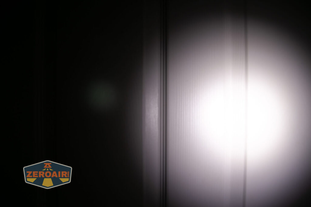 Olight Baton Turbo Orange flashlight beamshots on door compared to nichia 219b