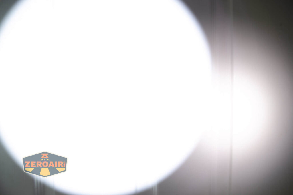 Olight Baton Turbo Orange flashlight beamshots on door compared to nichia 219b