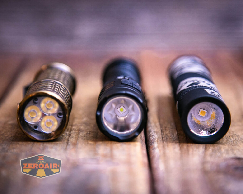 Sofirn SR12 pocket flashlight with two standard sized flashlights